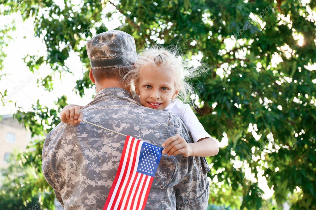 Happy military man with his little daughter outdoors
