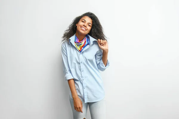 Beautiful young African-American woman on light background — Stock Photo, Image