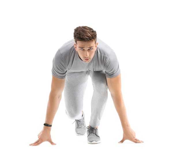 Sporty young man in crouch start position on white background — Stock Photo, Image