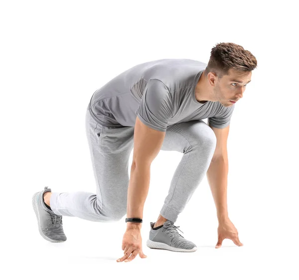 Sporty young man in crouch start position on white background — Stock Photo, Image