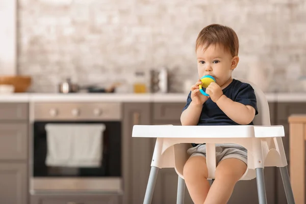 Cute little boy with nibbler in kitchen at home — Stock Photo, Image