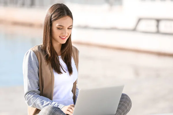 Vacker kvinnlig student med laptop utomhus — Stockfoto