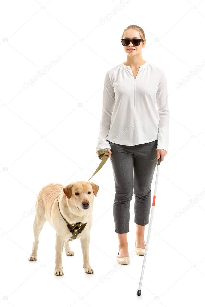 Young blind woman with guide dog on white background