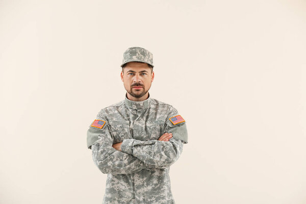 Soldier in camouflage on light background