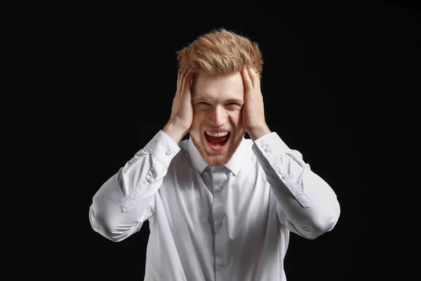 Stressed young man on dark background — Stock Photo, Image