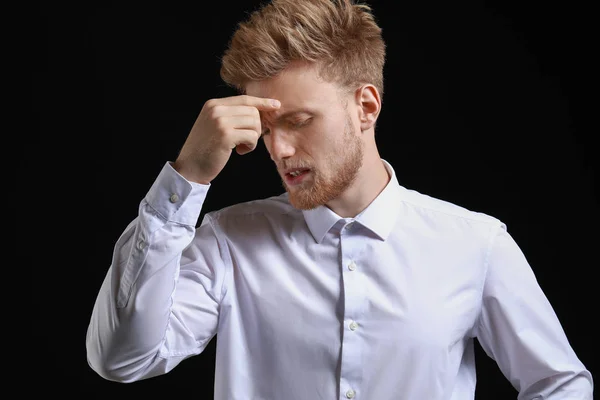 Stressed young man on dark background — Stock Photo, Image
