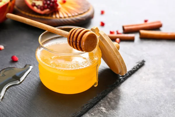 Jar of sweet honey and dipper on table — Stock Photo, Image