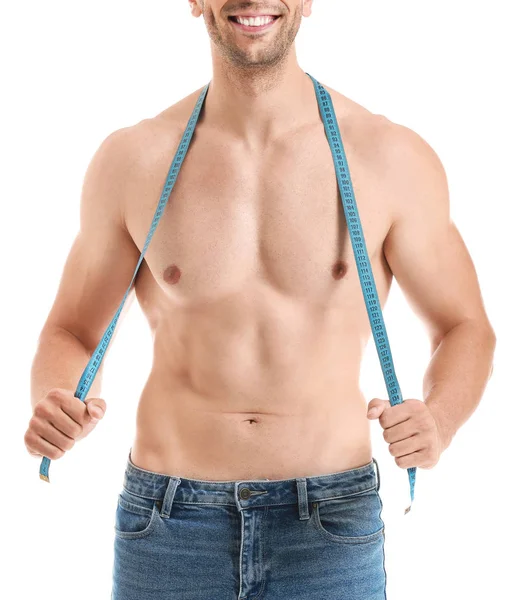 Handsome muscular man with measuring tape on white background. Weight loss concept — Stock Photo, Image