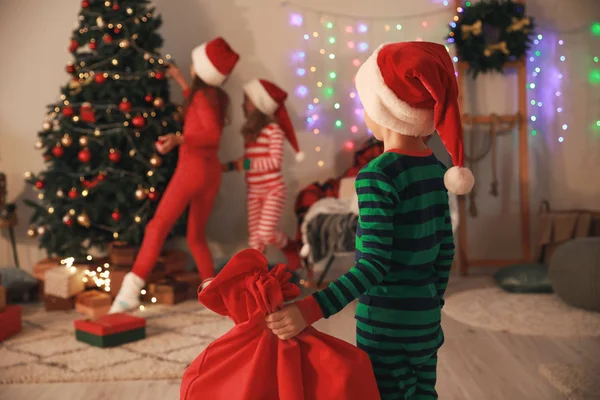 Little boy with gifts for his friends on Christmas eve — Stock Photo, Image