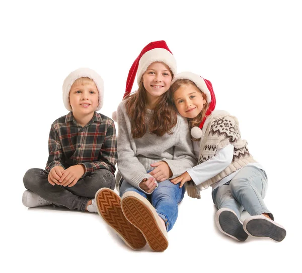 Cute little children in Santa Claus hats on white background — Stock Photo, Image