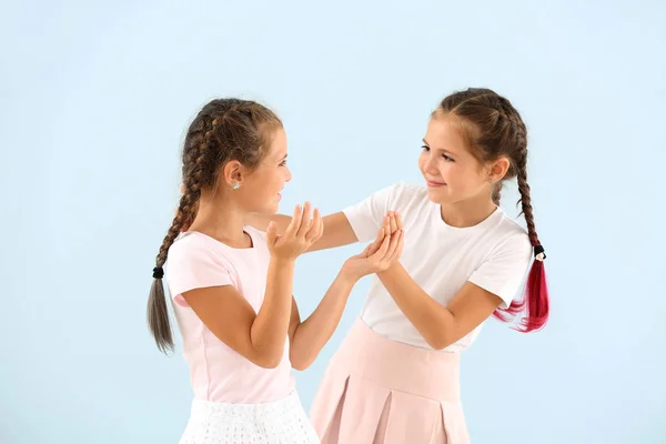 Portrait of cute twin girls on color background — Stock Photo, Image