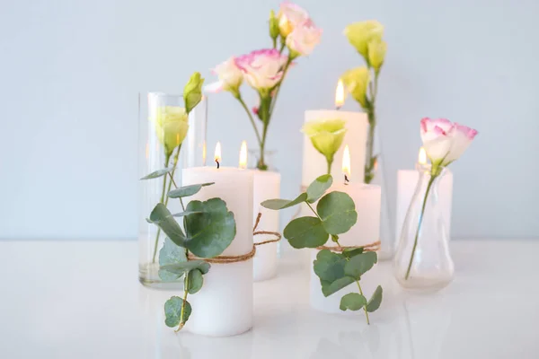 Composition with beautiful burning candles and flowers on table — Stock Photo, Image