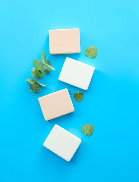 Soap bars with eucalyptus on color background — Stock Photo, Image