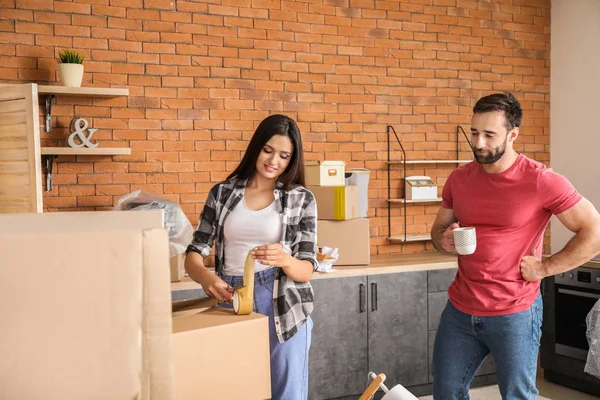 Young couple packing things before moving into new house