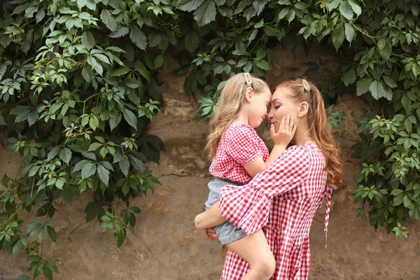 Portrait of beautiful woman and her little daughter outdoors — Stock Photo, Image