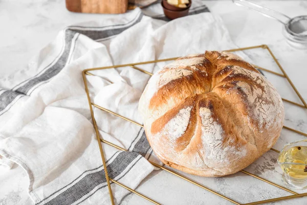 Tasty bread with oil on light table — Stock Photo, Image