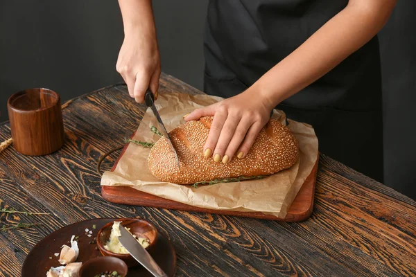 Nő vágás friss kenyér az asztalnál, Vértes — Stock Fotó