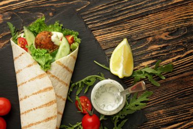 Ahşap arka planda lezzetli falafel pide ile kayrak plaka