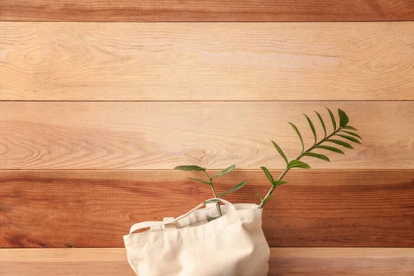 Bolso ecológico con planta sobre fondo de madera — Foto de Stock