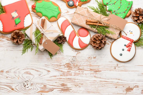 Tasty Christmas cookies with gifts on wooden background — Stock Photo, Image