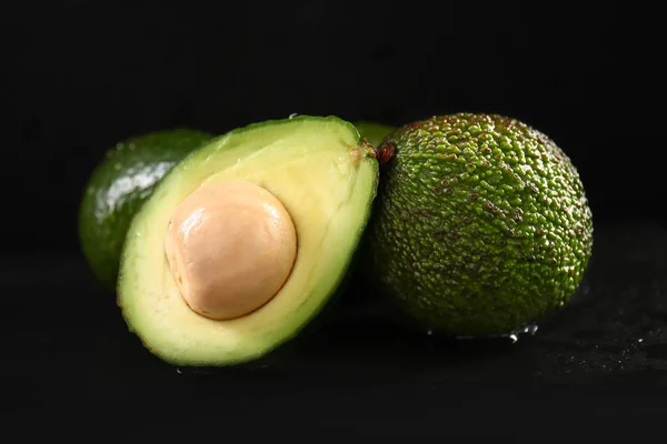 Ripe avocados on dark table — Stock Photo, Image