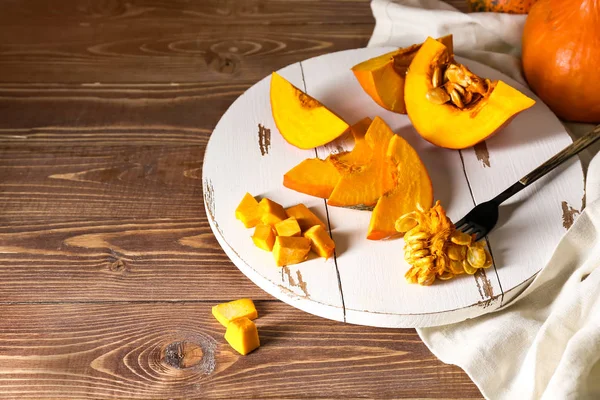 Pieces of fresh pumpkin on wooden table — Stock Photo, Image