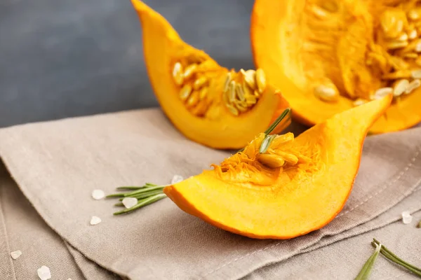 Fresh pumpkin with salt and rosemary on table — Stock Photo, Image