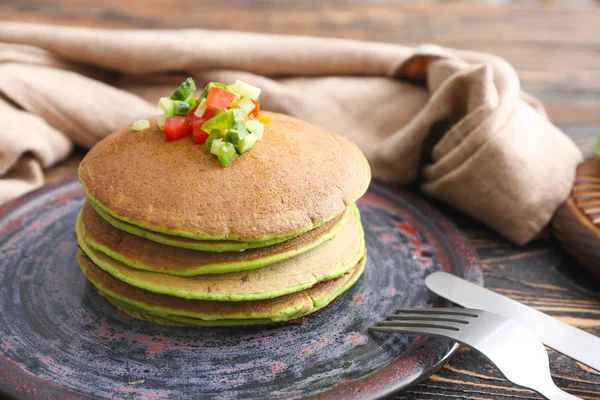 Plate with tasty green pancakes on table — Stock Photo, Image