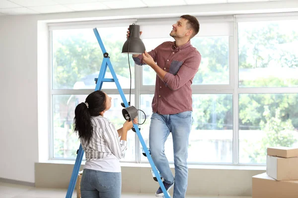 Lyckligt par gör reparation i sitt nya hus — Stockfoto