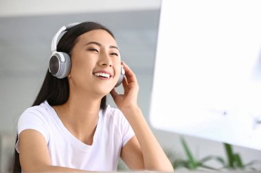 Sınava hazırlanırken müzik dinleyen genç Asyalı öğrenci