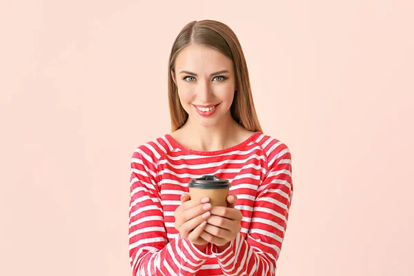 Beautiful young woman with cup of coffee on color background — Stock Photo, Image