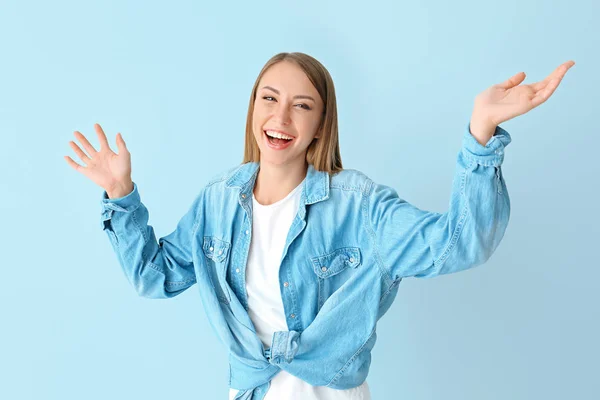 Happy young woman on color background