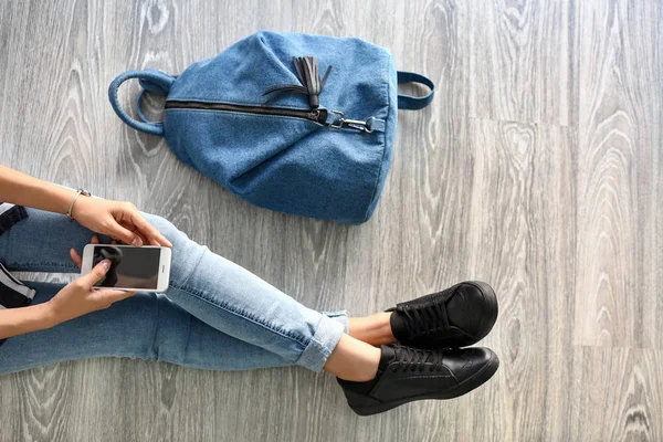 Young student sitting on floor in university — Stock Photo, Image