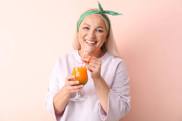 Mujer madura feliz con cóctel fresco sobre fondo claro — Foto de Stock