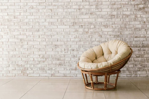 Stylish armchair near brick wall in living room — Stock Photo, Image