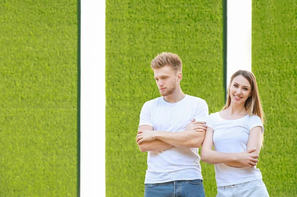 Man and woman in stylish t-shirts on color background — Stock Photo, Image