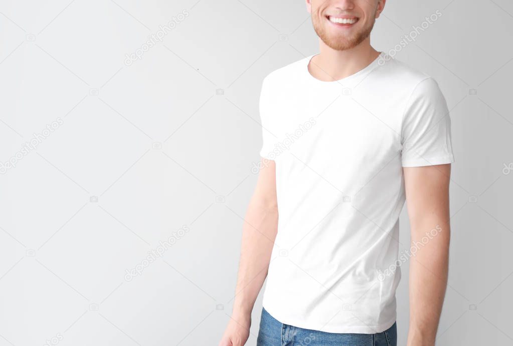 Man in stylish t-shirt on light background