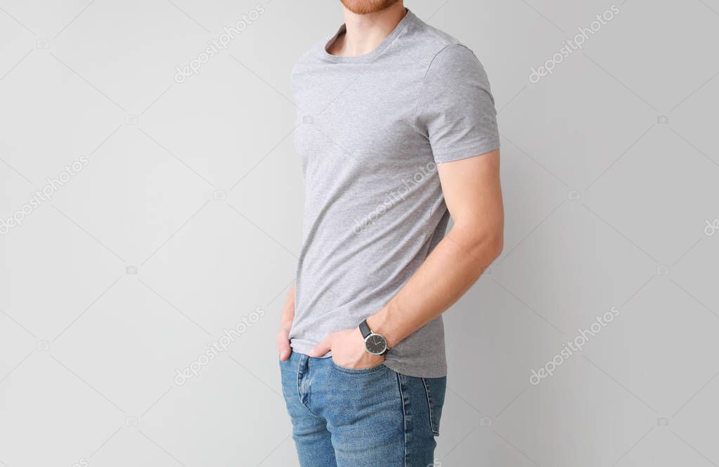 Man in stylish t-shirt on light background