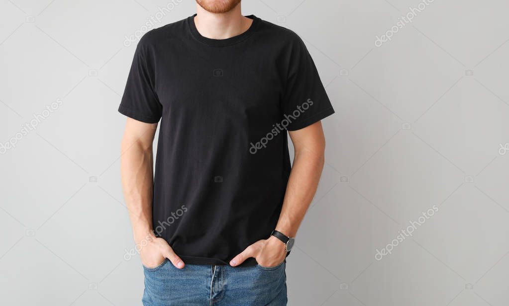 Man in stylish t-shirt on light background