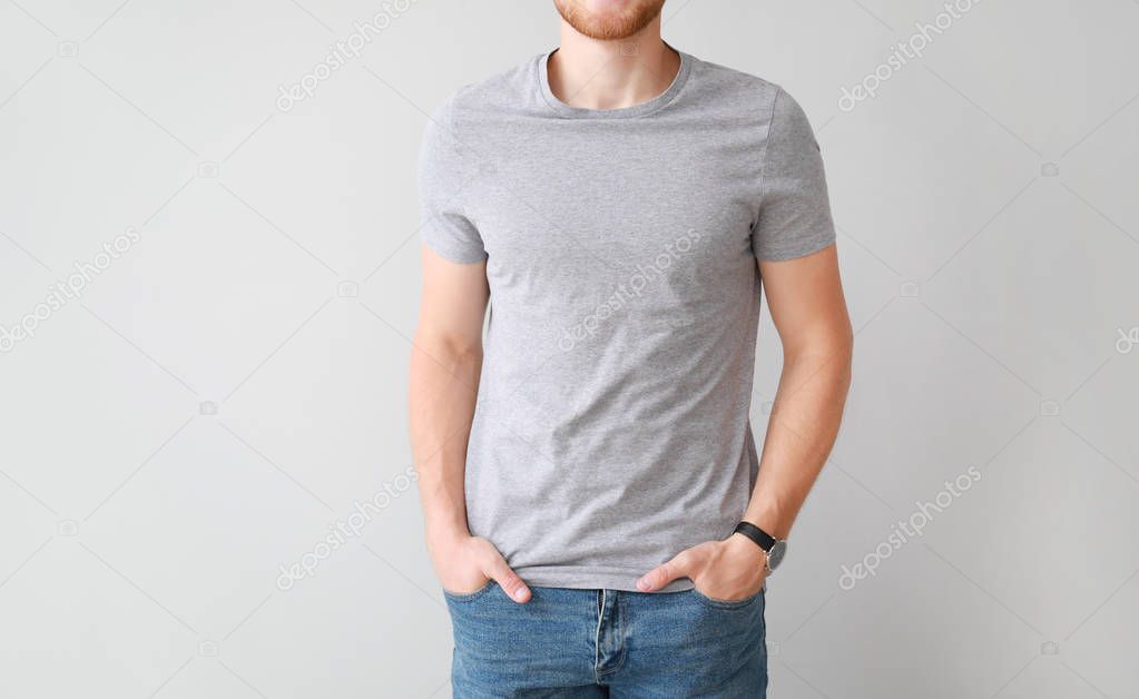Man in stylish t-shirt on light background