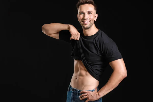 Handsome muscular man on dark background. Weight loss concept — Stock Photo, Image