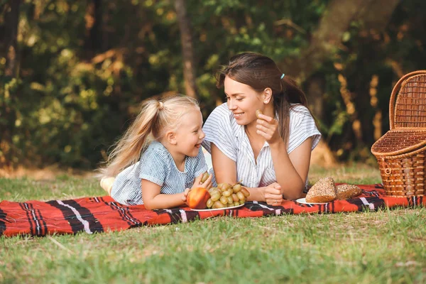 Happy mother and daughter at picnic outdoors — Stock Photo, Image