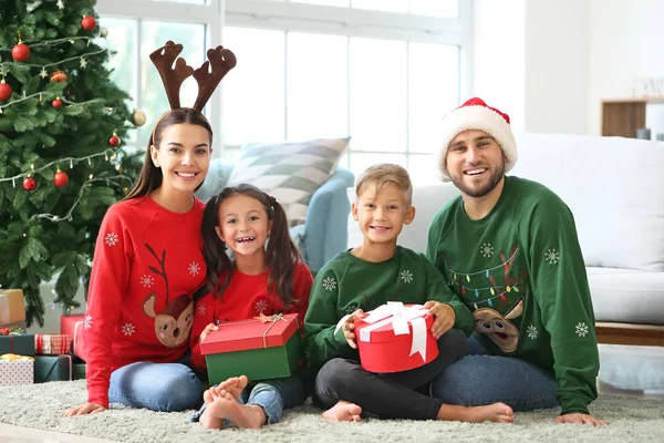 Happy family with gifts at home on Christmas eve — Stock Photo, Image