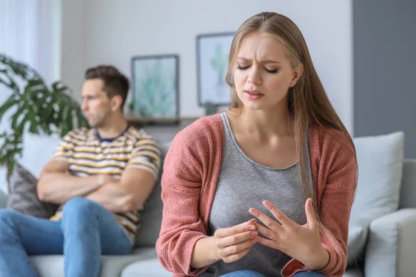 Sad young woman taking off her wedding ring at home. Concept of divorce — Stock Photo, Image