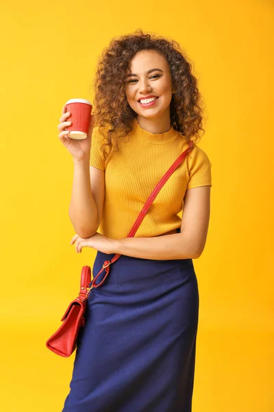 Mulher afro-americana elegante com xícara de café no fundo de cor — Fotografia de Stock