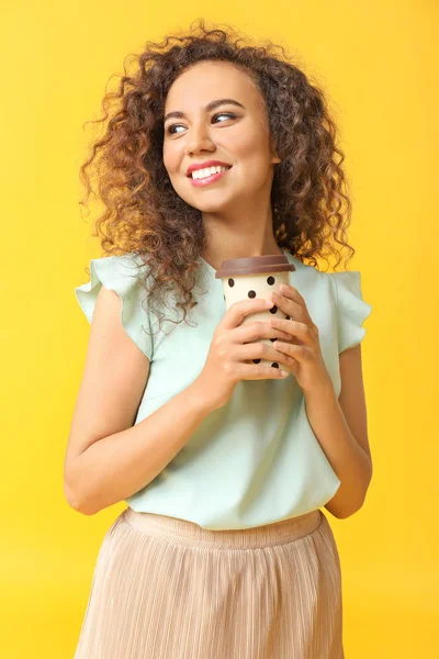 Mulher afro-americana feliz com xícara de café no fundo de cor — Fotografia de Stock