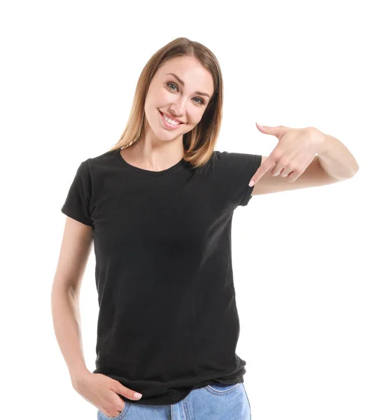 Woman pointing at her t-shirt against white background — Stock Photo, Image