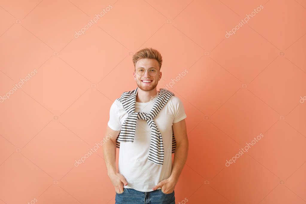 Man in stylish t-shirt on color background