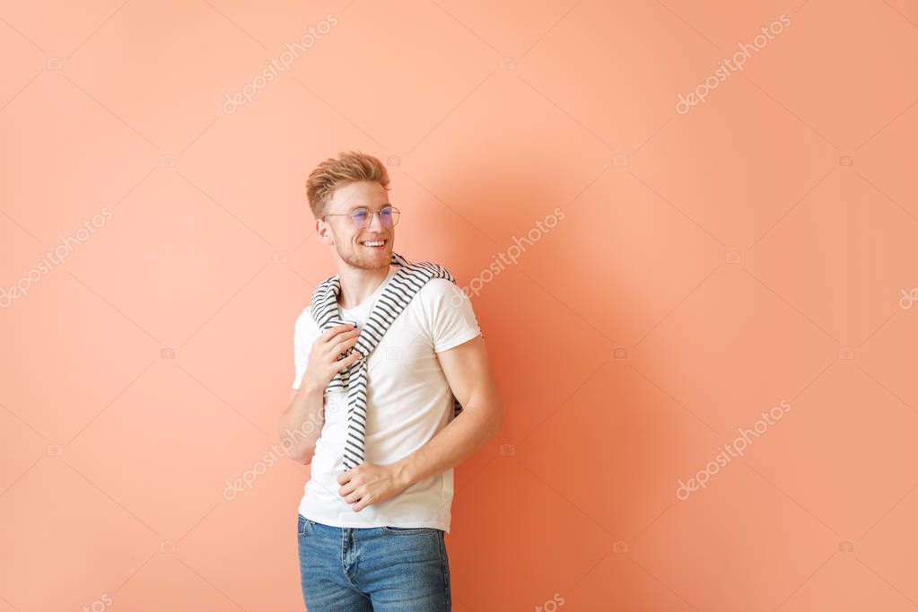 Man in stylish t-shirt on color background