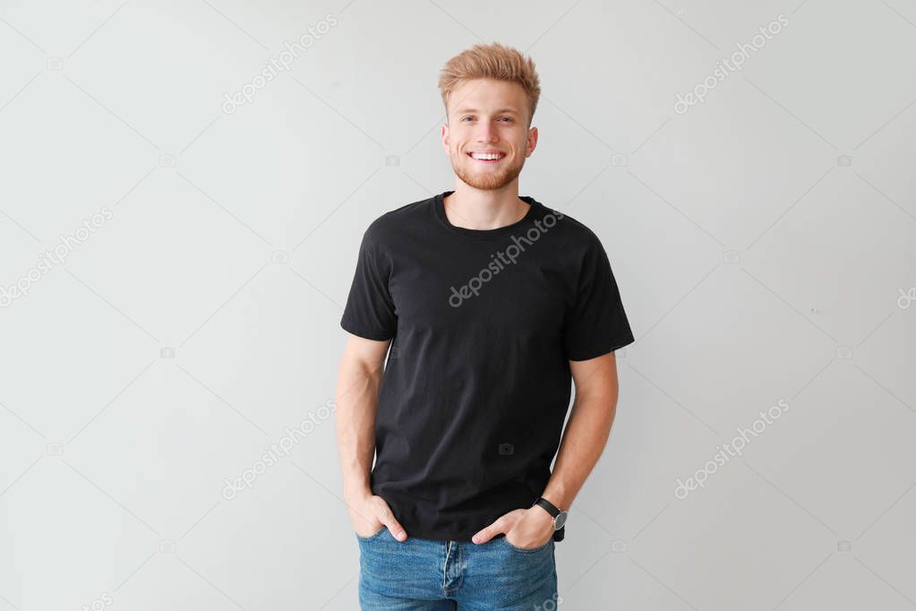 Man in stylish t-shirt on light background